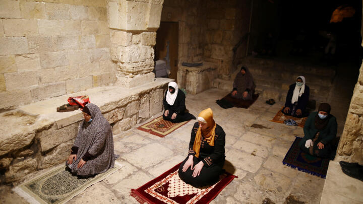 Muslim worshipers hold Ramadan prayers in Jerusalem's Old City on April 27, 2020, when a strict lockdown to stop the spread of the coronavirus kept mosques closed around the country. Houses of worship have gradually opened, but the number of worshipers allowed to gather is still limited.